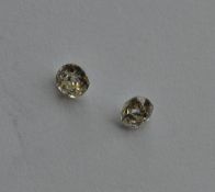 A pair of unmounted diamonds. Approx. 0.35 carats.