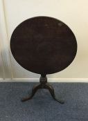 A mahogany pillar table with tilt top. Est. £40 -