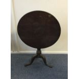 A mahogany pillar table with tilt top. Est. £40 -