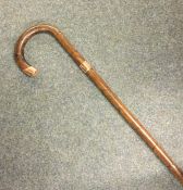 A gold mounted walking stick. Est. £25 - £35.