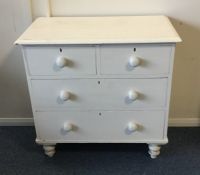 A pine chest of four drawers on turned supports. E