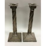A pair of Edwardian silver candlesticks with swirl