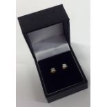 A pair of diamond single ear studs in two colour c