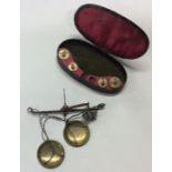 A Georgian cased miniature set of brass pan scales
