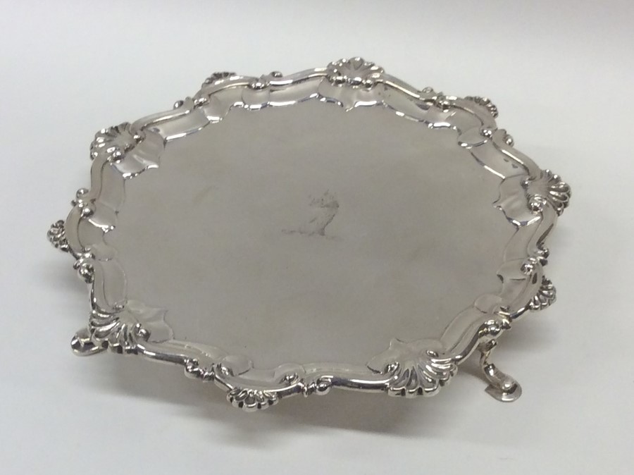 A Georgian silver small waiter with shell border.