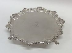 A Georgian silver small waiter with shell border.