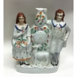 A large Staffordshire figure depicting a clock and