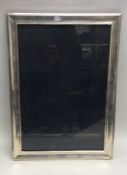 A massive rectangular silver picture frame with eb