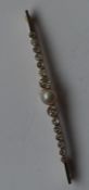 A large pearl and diamond brooch with large centra