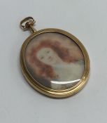 An attractive oval gold miniature of a lady with h