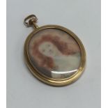 An attractive oval gold miniature of a lady with h