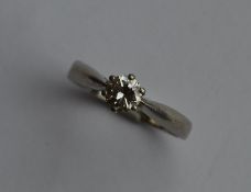 A diamond single stone ring in platinum claw mount