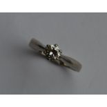 A diamond single stone ring in platinum claw mount