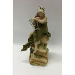 A Royal Dux figure of a harpist on rocky base. Est