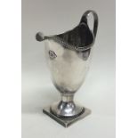 A Georgian silver helmet shaped cream jug with bea