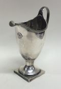 A Georgian silver helmet shaped cream jug with bea