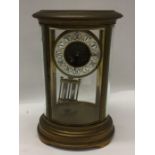 A large French oval mantle clock with white enamel