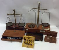 A box containing old jeweller's scales and weights