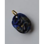 A large lapis pendant of Oriental design with gold