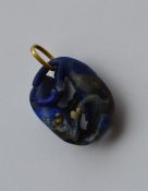A large lapis pendant of Oriental design with gold