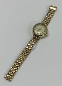 A 9 carat lady's wristwatch on mesh strap. Approx.