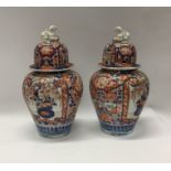 A pair of Japanese 19th Century Imari vases and co