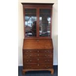 A tall mahogany bureau bookcase with fall front an