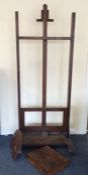 A tall mahogany artist's easel complete with palet