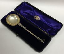 A cased silver presentation spoon with twisted ste
