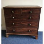 A mahogany chest of five drawers on bracket feet.