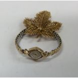 A gold plated Trifari brooch together with a lady'