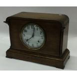 An oak cased mantle clock with white enamelled dia