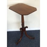 A slender mahogany pedestal table on three sweepin