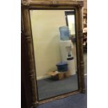 A good Antique gilt mirror with fluted sides. Est.
