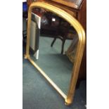 An oval top gilt mantle mirror on porcelain suppor