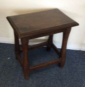 A Georgian oak coffin stool on tapering supports.