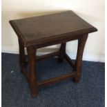 A Georgian oak coffin stool on tapering supports.