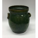 A green ground Devon pottery two handled jardinier