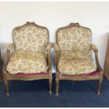 A good pair of gilt armchairs decorated with scrol