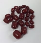 A bag containing tapering red amber beads of oval