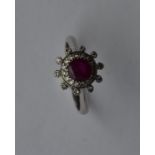 An attractive ruby and diamond circular cluster in