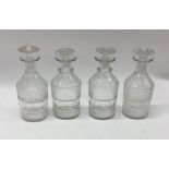 A set of four Antique glass decanters with lift-ou