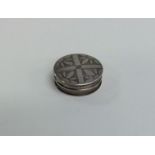 A Georgian silver circular pill box engraved with