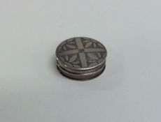 A Georgian silver circular pill box engraved with