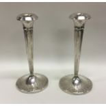 A pair of stylish silver candlesticks of tapering