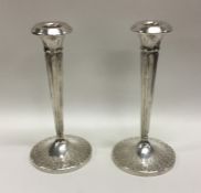 A pair of stylish silver candlesticks of tapering