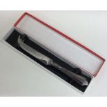 A cased modern silver cheese knife in fitted box.