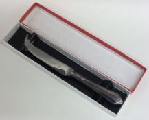 A cased modern silver cheese knife in fitted box.