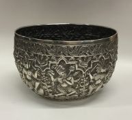 A heavy Indian silver bowl decorated with figures