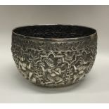 A heavy Indian silver bowl decorated with figures
